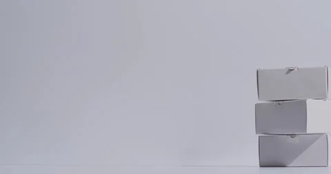 Video of stacked cardboard boxes with copy space over white background Stock Footage 331208558
