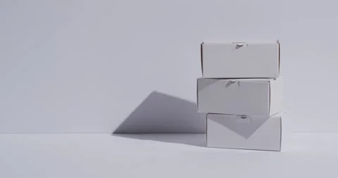 Video of stacked cardboard boxes with copy space over white background Stock Footage 331307293