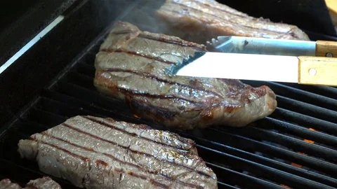 Video of steaks on the fire in real slow motion Stock Footage 79678376