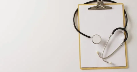 Video of stethoscope with blank white paper on clipboard, on white background Stock Footage 331307138