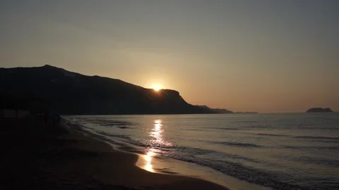 A video of the sun peaking over the mountain on Kalamaki Beach on the Islan.. Stock Footage 252972757