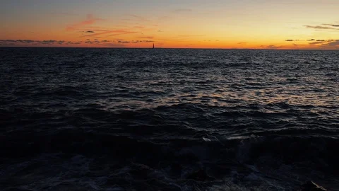 Video of sunset seen from fast moving boat . Aegean sea at sunset. Looking at Stock Footage 129783459