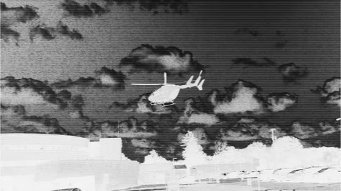 Video surveillance of a medical helicopter hovering over community Stock Footage