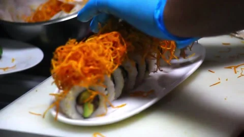 Video Sushi roll in the making wearing blue gloves Vídeos de archivo 157560962