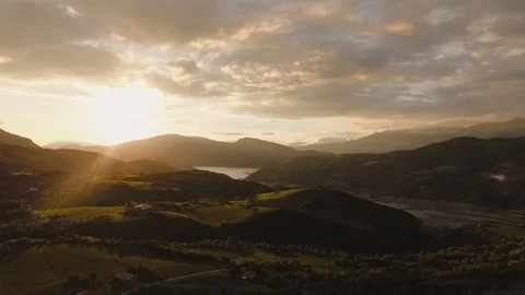 Video taken with a drone showing a sunset over a lake and the mountains Stock Footage
