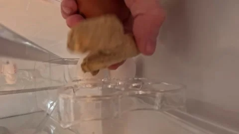Video taking an egg out of the fridge. Видео 332802660