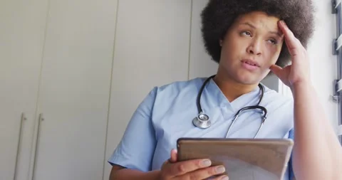 Video of tired plus size african american female doctor using tablet Video stock 342715213