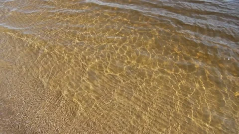 Video, top to bottom, transparent moving seawater, sandy bottom.No People. Stock Footage 170874870