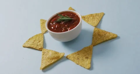 Video of tortilla chips and salsa dip on a grey surface Stock Footage 340256360