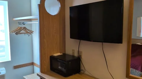 Video tour of a modest generic motel room with television, microwave Stock Footage 339633743
