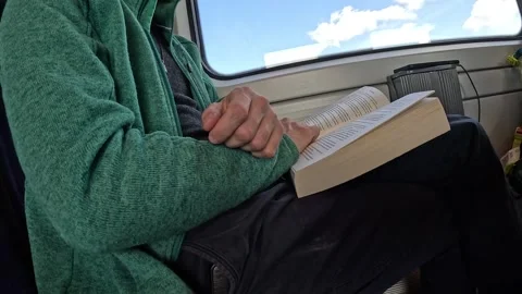 Video of train passenger reading a book. Video stock 333212670