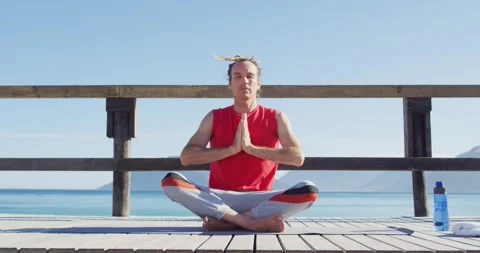 Video of tranquil caucasian man with dreadlocks practicing yoga meditation Stock Footage 335865990