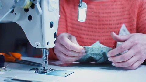 Video tutorial on stitching fabric into a protective mask at home. COVID 19 Stock Footage 128165437