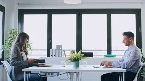 Video of two attractive business people shaking their hands while smiling aft Stock Footage 153242653