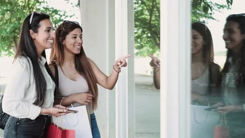 Video of two beautiful friends talking and having fun while walking on the ci Stock Footage 221473595