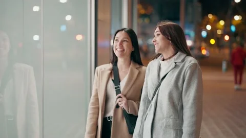 Video of two beautiful friends talking and having fun while walking on the .. Stock Footage 235908037