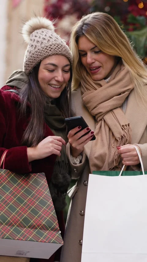 Video of two beautiful friends talking and using smartphone while walking o.. Stock Footage 340825471