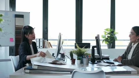 Video of two beautiful young designer women working in a design project with  Video stock 154829010