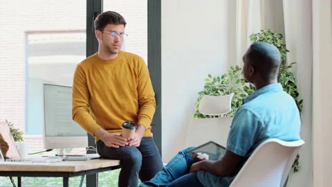 Video of two graphic designer taking a break while talking and having fun tog Stock Footage 167079653