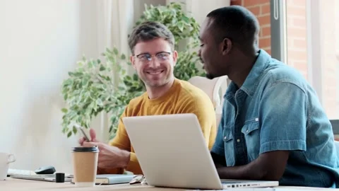 Video of two graphic designer working with laptop while celebrating something Stock Footage 167079675