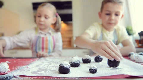 Video of two happy children having fun during preparation chocolate cookies Stock Footage 108063653