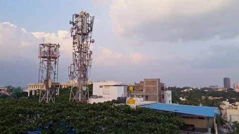 A video of two mobile network towers standing against the cloudy sky amidst.. 스톡 동영상 325771624