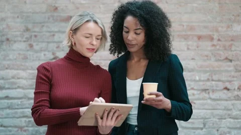 Video of two smart and elegant businesswomen talking while using digital ta.. Stock Footage 238804132