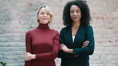 Video of two smart and elegant businesswomen looking at camera while smilin.. Stock Footage 238804139
