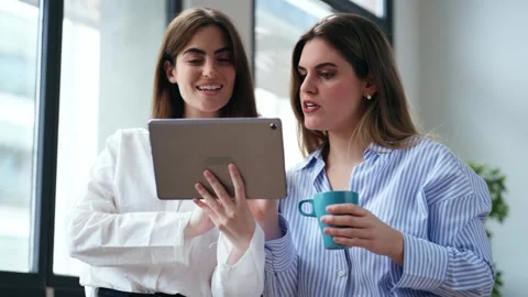 Video of two smart pretty business women taking a break while cheaking her .. Video stock 313357119