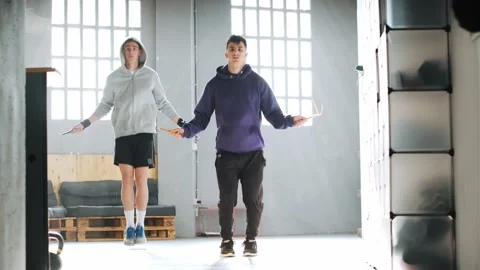 Video of two young men doing hard exercise workout in gym interior with rope  Stock Footage 172471406