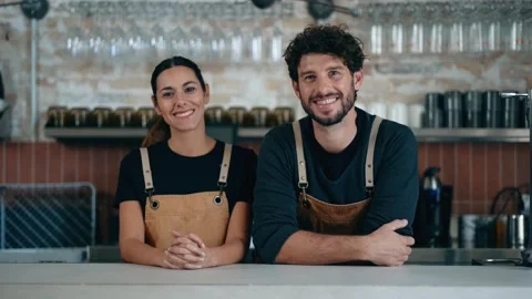 Video of two younger waiters looking at camera in a pastry shop. Stock Footage 303369726