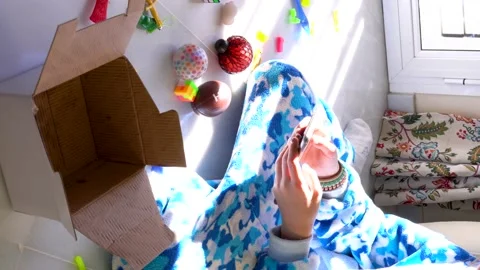 Video in vertical format: Crop anonymous kid in soft pajama sitting on floor Stock Footage 167141682