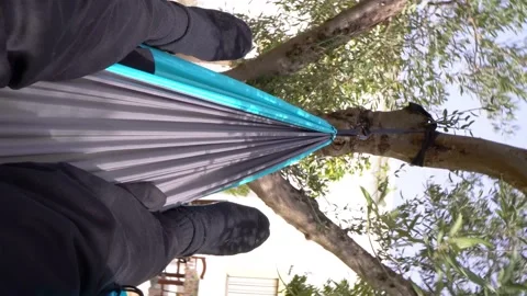 Video in vertical format: First person view of person lying in a hammock in t Stock Footage 170884884