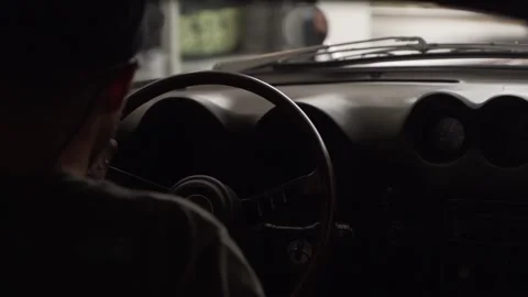 Video view from behind the shoulder of a driver in a classic car. Footage. View Stockbeeldmateriaal 138714248