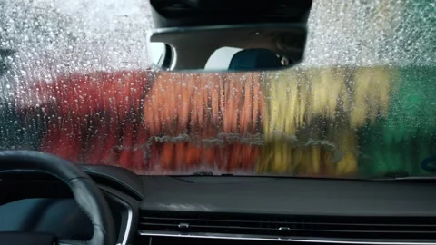 Video of view from inside a car while it is being cleaned at a car wash Stock Footage 243176759