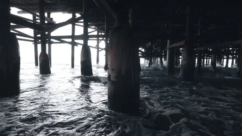 Video of walking under pier in 4K Stock Footage 77457917