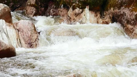 Video of water running strong in a river with stones. Concept nature and rivers. Stock Footage 238968969