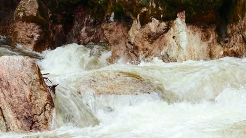 Video of water running strong in a river with stones. Concept nature and rivers. Stock Footage 238968975