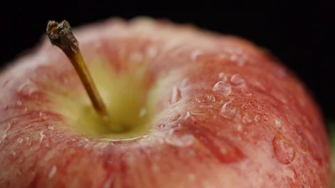 In the video we see a red apple, the water begins to pour from the top like a Stock Footage 115798607