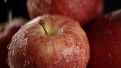In the video we see red apples, drops fall from the top, then hard rain starts 스톡 동영상 114429973