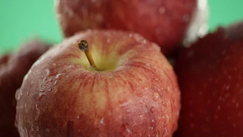 In the video we see red apples, then the water begins to fall from the top in Stock Footage 114431349