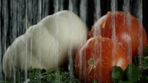 In the video we see a white pumpkin, tomatoes and greens, water pours from the Stock Footage 114434603