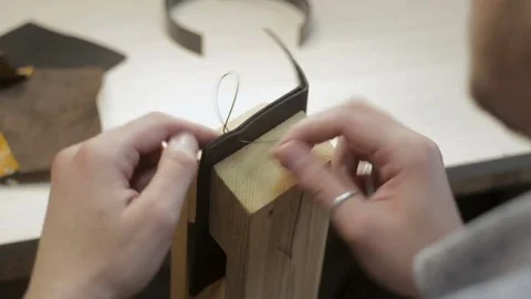 Video where master creates a black leather wallet with his own hands with a n 스톡 동영상 82056214