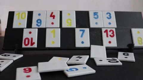 Video in which we have a rummy board and a person throwing rummy pieces at it Stock Footage 181550726