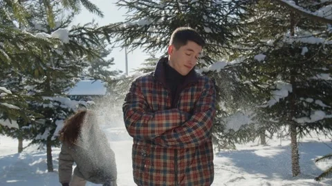 A video in which a young guy stands with his arms crossed, and a girl throws Stock Footage 237033175