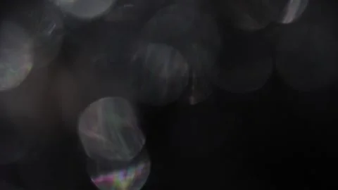 Video of white bokeh spherical light moving left on black background 库存影片 317452894