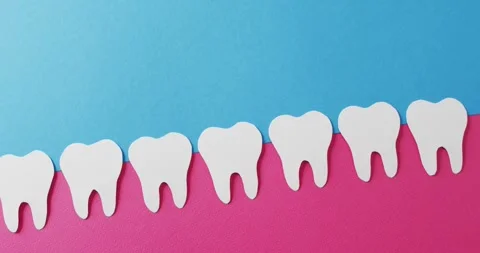 Video of white paper teeth in pink gum on blue background with copy space Stock Footage 331245915