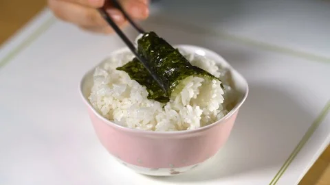 Video of white rice with seaweed using chopsticks Stock Footage 76935425