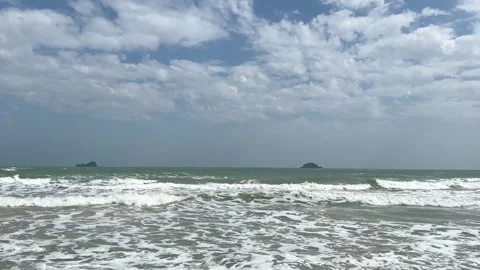 Video of wind blowing ocean waves during daytime with scattered clouds Stock Footage 325417637