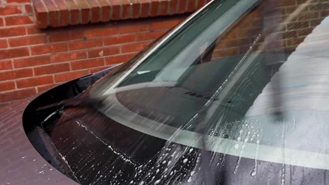 Video of windshield wipers moving around washer fluid. Stock Footage 341681746